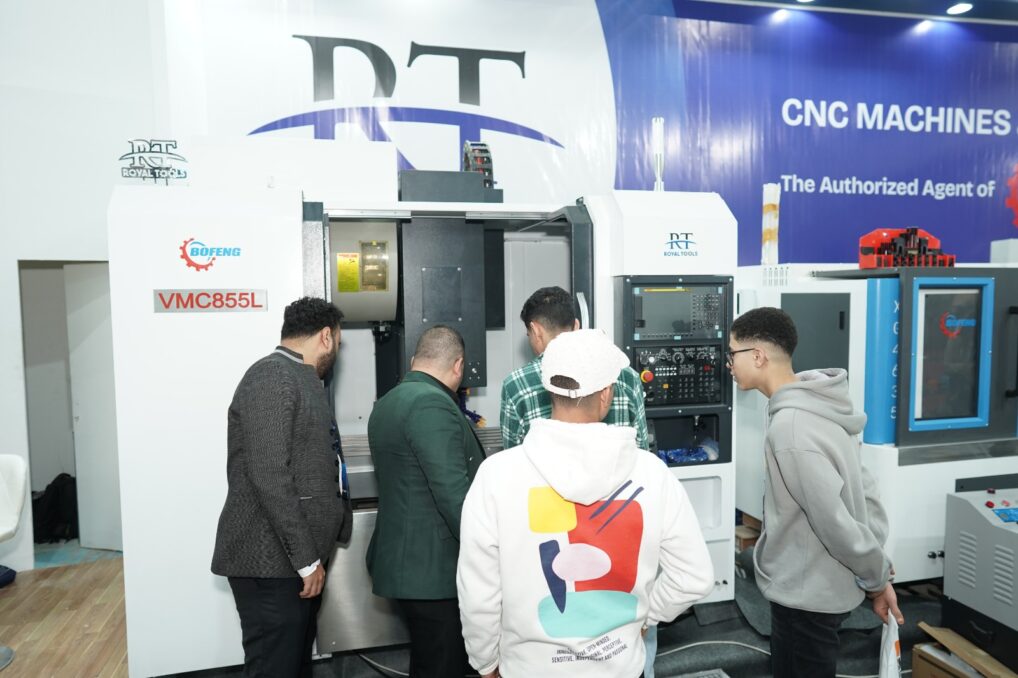 Visitors viewing industrial machinery at a previous MACTECH exhibition